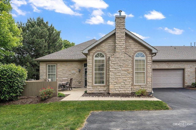 3319 Timbers Edge Cir, Joliet, IL 60431 - rear view of house featuring stone siding, a garage, and a shingled roof