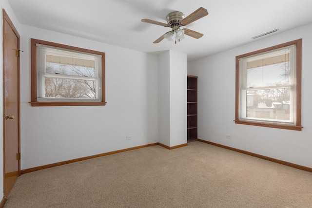 1141 Hartford Ln, Elk Grove Village, IL 60007 - unfurnished bedroom with light colored carpet, baseboards, and ceiling fan