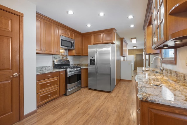 1141 Hartford Ln, Elk Grove Village, IL 60007 - kitchen featuring appliances with stainless steel finishes, brown cabinets, light wood-style flooring, light stone countertops, and glass insert cabinets
