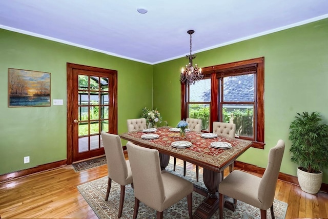 204 W Florida Ave, Urbana, IL 61801 - dining area with a chandelier, light wood-style floors, and crown molding