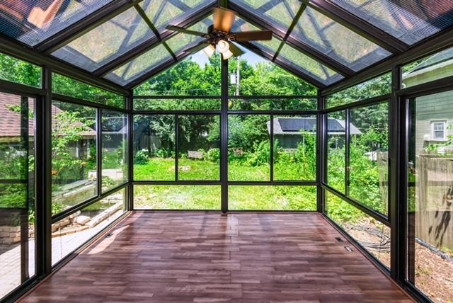 204 W Florida Ave, Urbana, IL 61801 - unfurnished sunroom with lofted ceiling, ceiling fan, and plenty of natural light