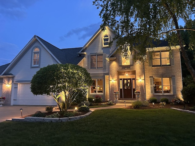 24255 Cropland Dr, Plainfield, IL 60544 - traditional home with concrete driveway, a front yard, an attached garage, and brick siding