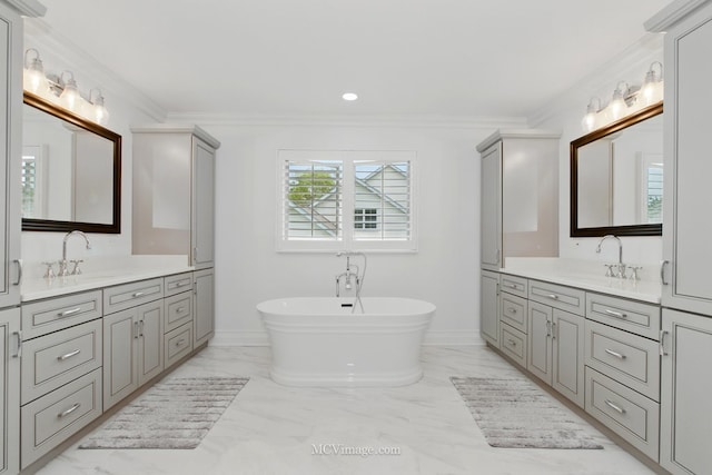 24255 Cropland Dr, Plainfield, IL 60544 - bathroom featuring two vanities, marble finish flooring, a soaking tub, crown molding, and recessed lighting