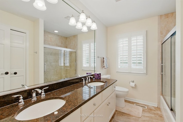 24255 Cropland Dr, Plainfield, IL 60544 - full bathroom featuring double vanity, toilet, baseboards, and enclosed tub / shower combo