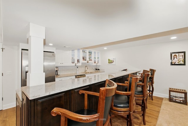 24255 Cropland Dr, Plainfield, IL 60544 - indoor wet bar with tasteful backsplash, light wood-style floors, baseboards, recessed lighting, and stainless steel fridge