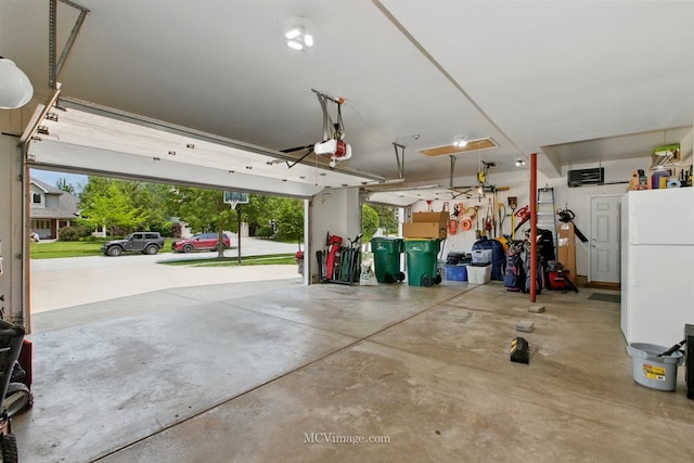 24255 Cropland Dr, Plainfield, IL 60544 - garage with freestanding refrigerator and a garage door opener