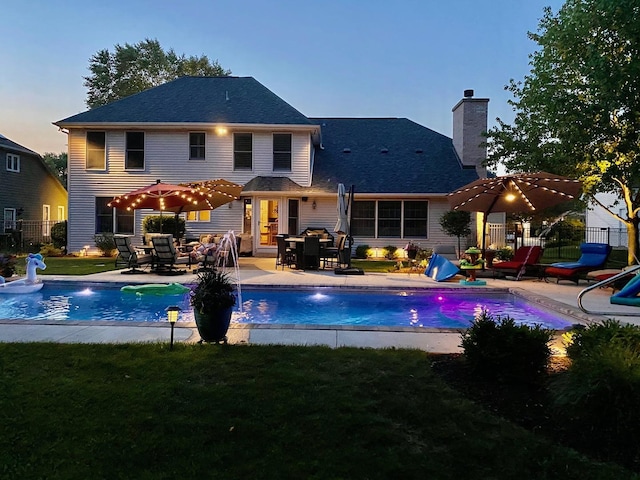 24255 Cropland Dr, Plainfield, IL 60544 - back of property at dusk with a chimney and a patio area