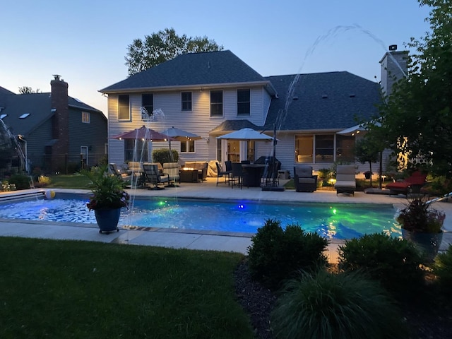 24255 Cropland Dr, Plainfield, IL 60544 - pool at dusk featuring an outdoor pool, an outdoor living space, and a patio area