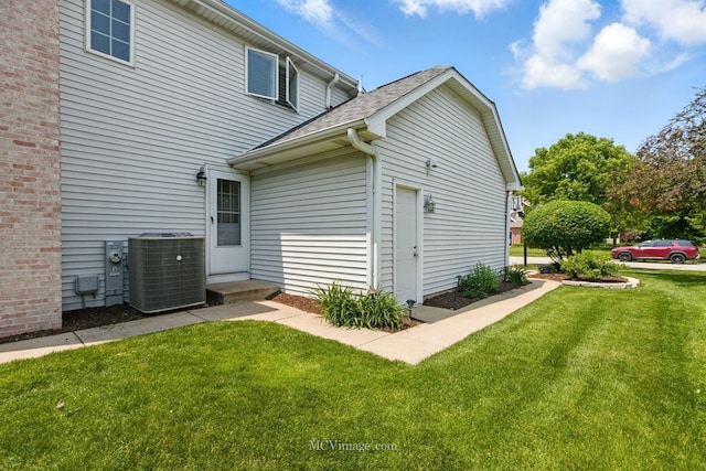 24255 Cropland Dr, Plainfield, IL 60544 - view of property exterior featuring central AC, a yard, and roof with shingles