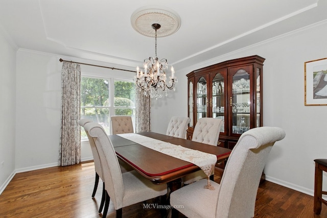 24255 Cropland Dr, Plainfield, IL 60544 - dining space with a chandelier, a tray ceiling, wood finished floors, baseboards, and ornamental molding