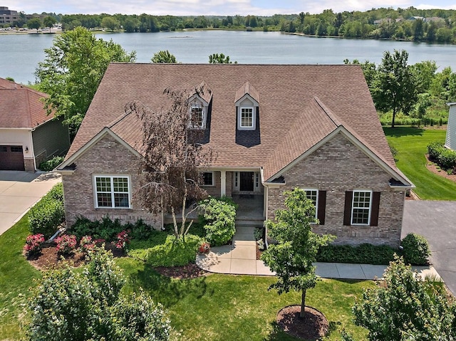 23521 N Sanctuary Club Dr, Kildeer, IL 60047 - cape cod-style house featuring brick siding, a water view, a shingled roof, and a front lawn