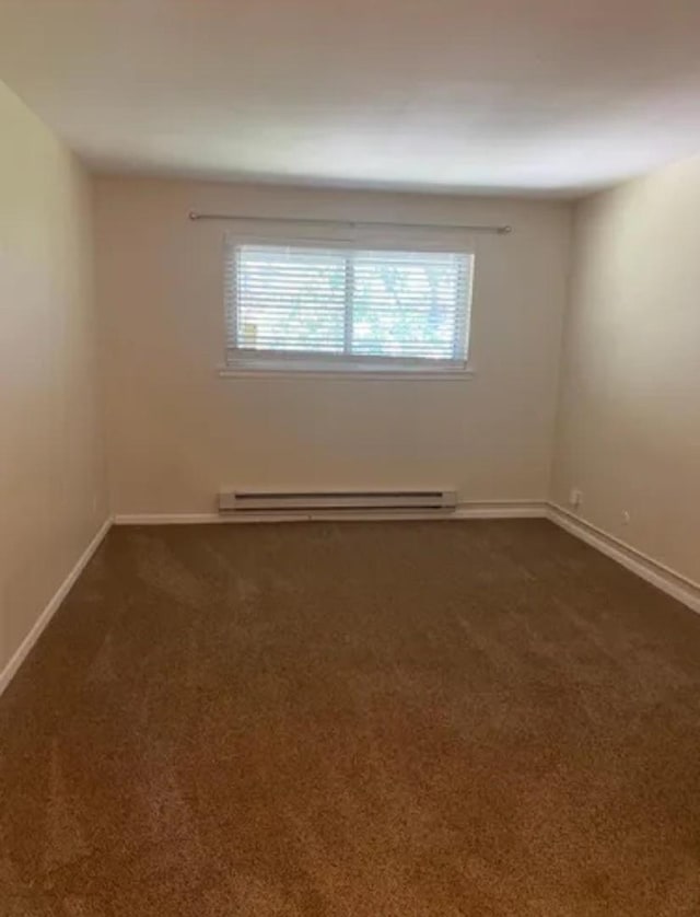 1840 W Hatherleigh Ct Unit 2D, Mount Prospect, IL 60056 - spare room featuring a baseboard radiator, dark carpet, and plenty of natural light