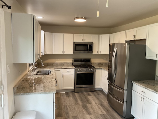 624 Catalpa Ln, Bartlett, IL 60103 - kitchen featuring appliances with stainless steel finishes, a sink, white cabinets, dark wood finished floors, and light stone counters