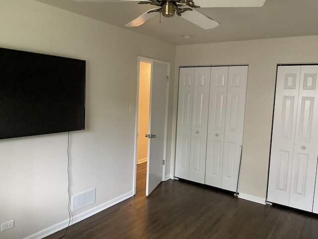 624 Catalpa Ln, Bartlett, IL 60103 - unfurnished bedroom with dark wood finished floors, multiple closets, baseboards, and ceiling fan