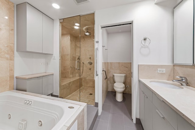 1000 N Lake Shore Plz Unit 17C, Chicago, IL 60611 - bathroom featuring tile walls, a stall shower, tile patterned floors, a tub with jets, and toilet