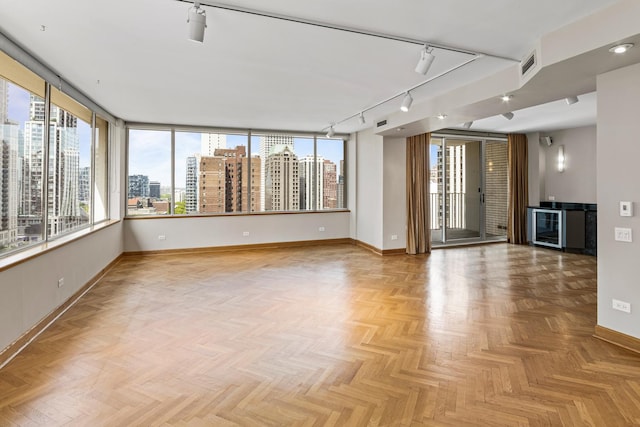 1000 N Lake Shore Plz Unit 17C, Chicago, IL 60611 - spare room with baseboards, a view of skyline, rail lighting, and plenty of natural light
