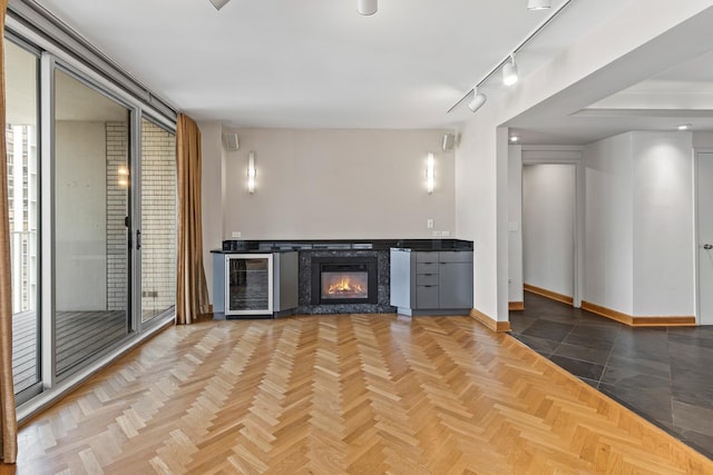 1000 N Lake Shore Plz Unit 17C, Chicago, IL 60611 - bar with wine cooler, baseboards, a glass covered fireplace, and track lighting