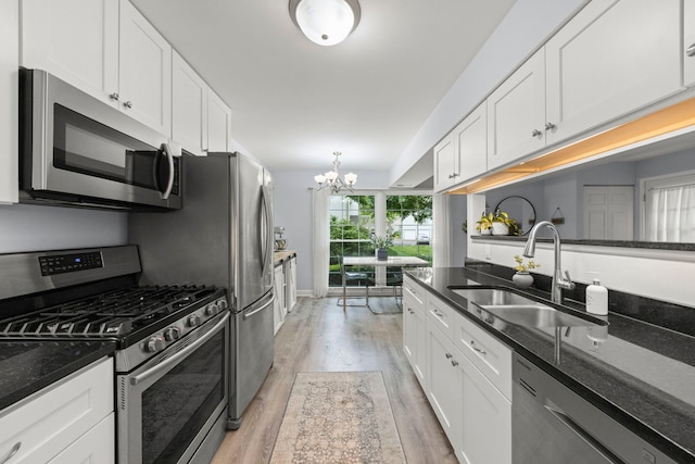 1693 Ashburn Ct Unit B, Wheaton, IL 60189 - kitchen with appliances with stainless steel finishes, a sink, a chandelier, and light wood-type flooring