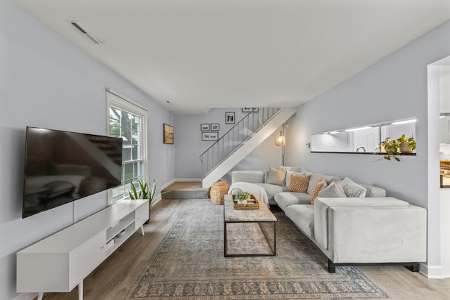 1693 Ashburn Ct Unit B, Wheaton, IL 60189 - living area featuring stairway, wood finished floors, and baseboards