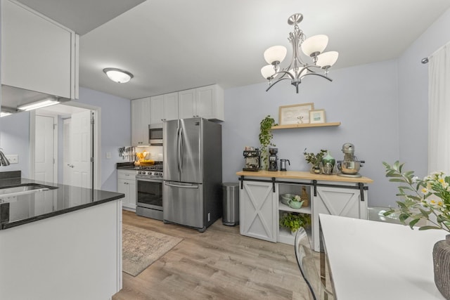 1693 Ashburn Ct Unit B, Wheaton, IL 60189 - kitchen with stainless steel appliances, a sink, white cabinetry, light wood-type flooring, and a chandelier