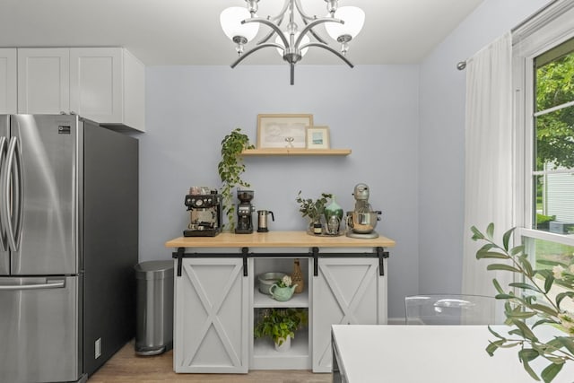 1693 Ashburn Ct Unit B, Wheaton, IL 60189 - kitchen featuring freestanding refrigerator, open shelves, a chandelier, and white cabinetry