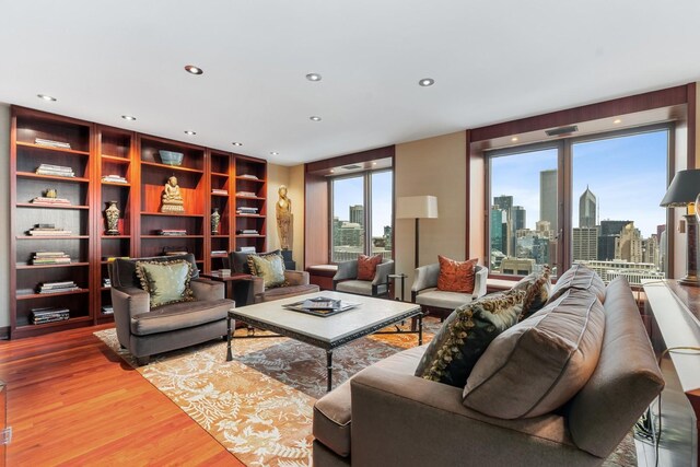 161 E Chicago Ave Unit 33De, Chicago, IL 60611 - living room with a view of skyline, wood finished floors, and recessed lighting