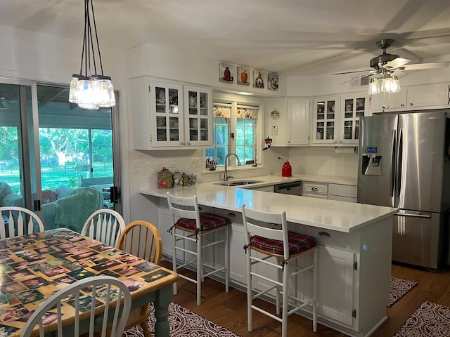 1539 Wincanton Dr, Deerfield, IL 60015 - kitchen with stainless steel appliances, a peninsula, a ceiling fan, and decorative backsplash