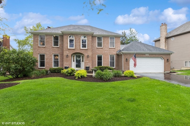 3022 Woods Creek Ln, Algonquin, IL 60102 - colonial-style house featuring a front yard, a garage, driveway, and brick siding