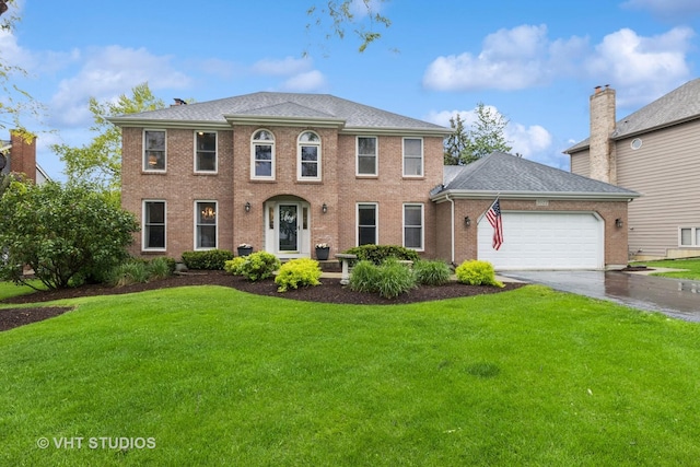 3022 Woods Creek Ln, Algonquin, IL 60102 - colonial home with a front yard, a garage, concrete driveway, and brick siding