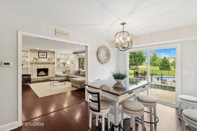 3022 Woods Creek Ln, Algonquin, IL 60102 - dining space featuring a chandelier, hardwood / wood-style flooring, plenty of natural light, a brick fireplace, and recessed lighting