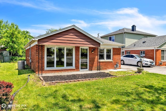 11617 S Kedzie Ave, Merrionette Park, IL 60803 - view of front of home featuring brick siding, a front lawn, and central AC