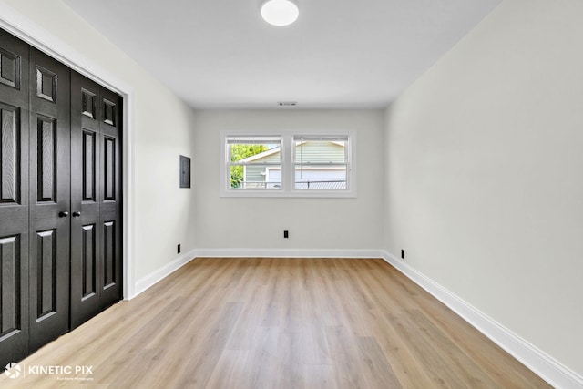 11617 S Kedzie Ave, Merrionette Park, IL 60803 - unfurnished bedroom with light wood-style flooring, baseboards, and a closet