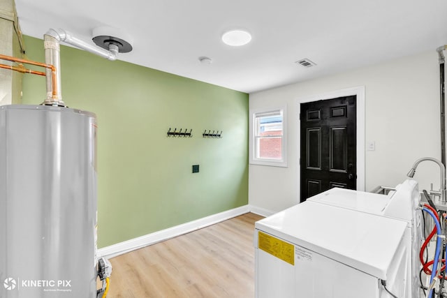 11617 S Kedzie Ave, Merrionette Park, IL 60803 - kitchen featuring washer and dryer, water heater, light wood-type flooring, and baseboards