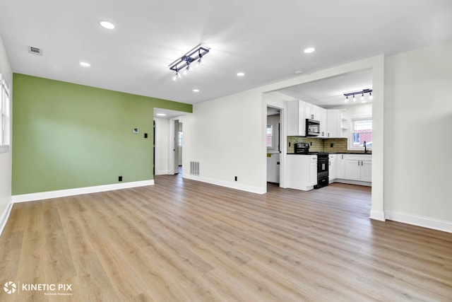 11617 S Kedzie Ave, Merrionette Park, IL 60803 - unfurnished living room featuring a sink, light wood-type flooring, recessed lighting, and baseboards