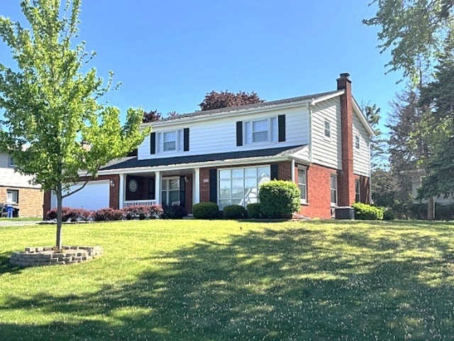 5N265 Neva Ter, Itasca, IL 60143 - traditional-style home featuring a chimney, a front lawn, brick siding, and central AC unit