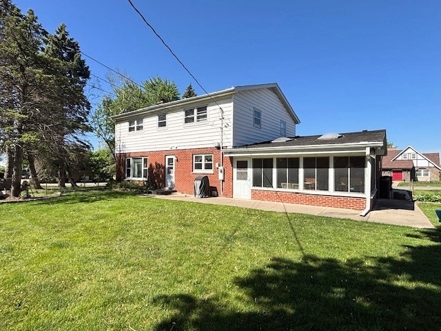 5N265 Neva Ter, Itasca, IL 60143 - rear view of property with a sunroom, brick siding, and a yard