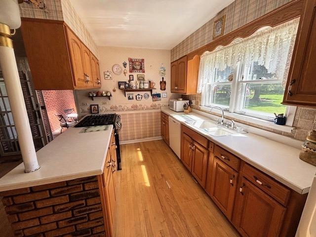 5N265 Neva Ter, Itasca, IL 60143 - kitchen featuring wallpapered walls, white appliances, light wood finished floors, a sink, and light countertops