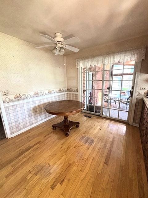 5N265 Neva Ter, Itasca, IL 60143 - unfurnished dining area featuring wood finished floors, a ceiling fan, and wallpapered walls