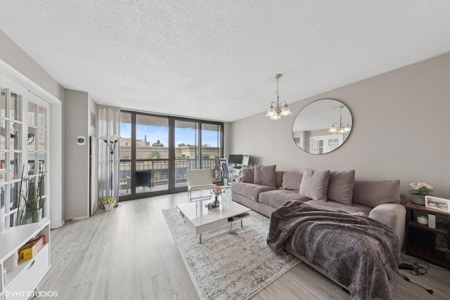 10 E Ontario St Unit 2806, Chicago, IL 60611 - living area with floor to ceiling windows, a chandelier, a textured ceiling, and wood finished floors