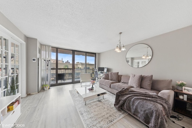 10 E Ontario St Unit 2806, Chicago, IL 60611 - living area with a wall of windows, a chandelier, a textured ceiling, and wood finished floors