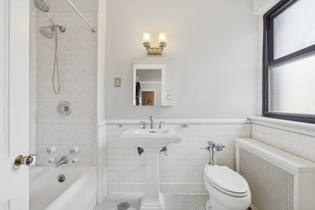 1755 E 55th St Unit 1204, Chicago, IL 60615 - bathroom featuring radiator heating unit, toilet, shower / bath combination, wainscoting, and tile walls