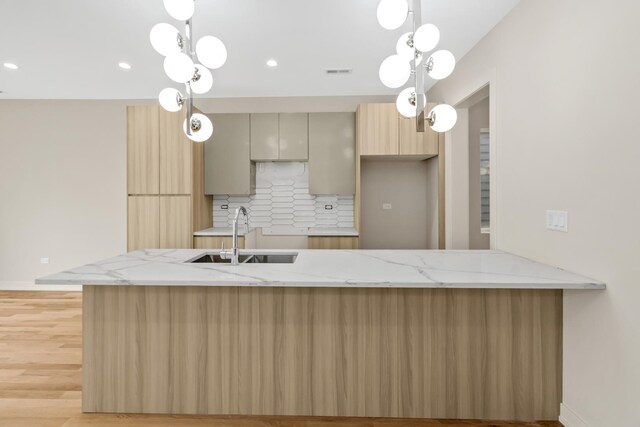 6513 S Langley Ave, Chicago, IL 60637 - kitchen with a sink, backsplash, light stone countertops, a peninsula, and modern cabinets