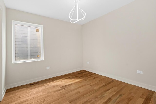 6513 S Langley Ave, Chicago, IL 60637 - empty room featuring light wood-style floors and baseboards