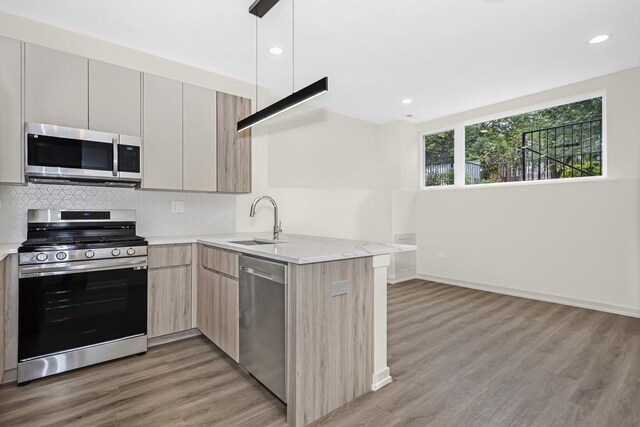 6513 S Langley Ave, Chicago, IL 60637 - kitchen with appliances with stainless steel finishes, a sink, light brown cabinetry, light wood finished floors, and recessed lighting