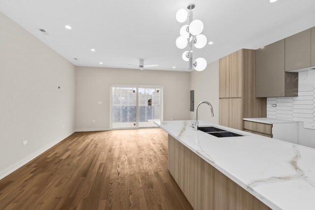 6513 S Langley Ave, Chicago, IL 60637 - kitchen featuring a sink, modern cabinets, light wood-style floors, backsplash, and recessed lighting