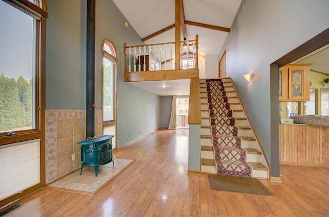 166 Fossil Cove Ln, Wilmington, IL 60481 - stairs with a wood stove, wood finished floors, high vaulted ceiling, beam ceiling, and baseboards