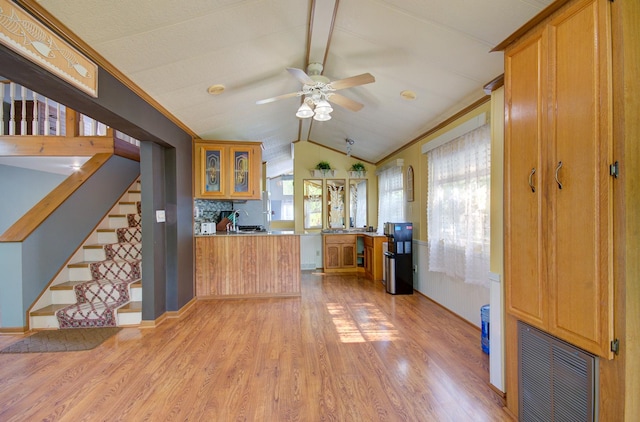 166 Fossil Cove Ln, Wilmington, IL 60481 - kitchen featuring light wood-type flooring, a ceiling fan, a peninsula, glass insert cabinets, and brown cabinetry