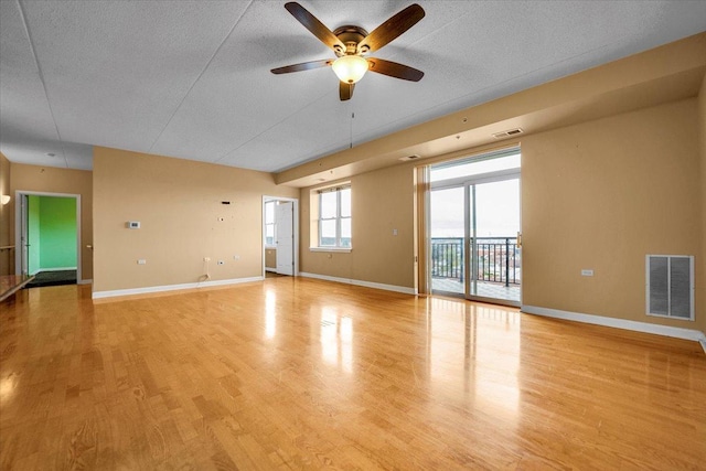 9355 Irving Park Rd Unit 506, Schiller Park, IL 60176 - unfurnished living room featuring a ceiling fan, light wood-type flooring, and a textured ceiling