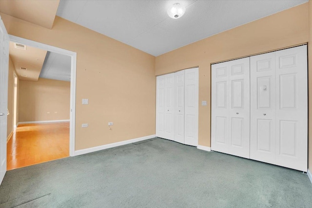 9355 Irving Park Rd Unit 506, Schiller Park, IL 60176 - unfurnished bedroom featuring multiple closets and carpet flooring