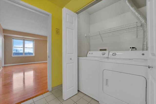 9355 Irving Park Rd Unit 506, Schiller Park, IL 60176 - laundry area with washer and dryer and light tile patterned floors